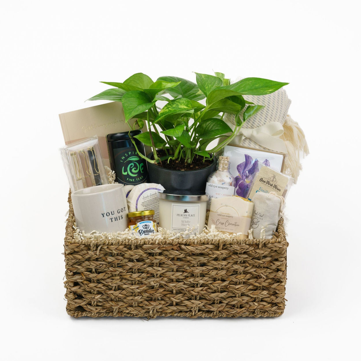 Medium-sized gift basket filled with artisanal, locally made items from small businesses, customizable for any recipient. Includes options like handcrafted candles, gourmet tea, natural soap, bath salts, journals, beach blankets, dish towels, kitchen items, specialty coffee, treats, and more, perfect for a personalized and thoughtful gift.